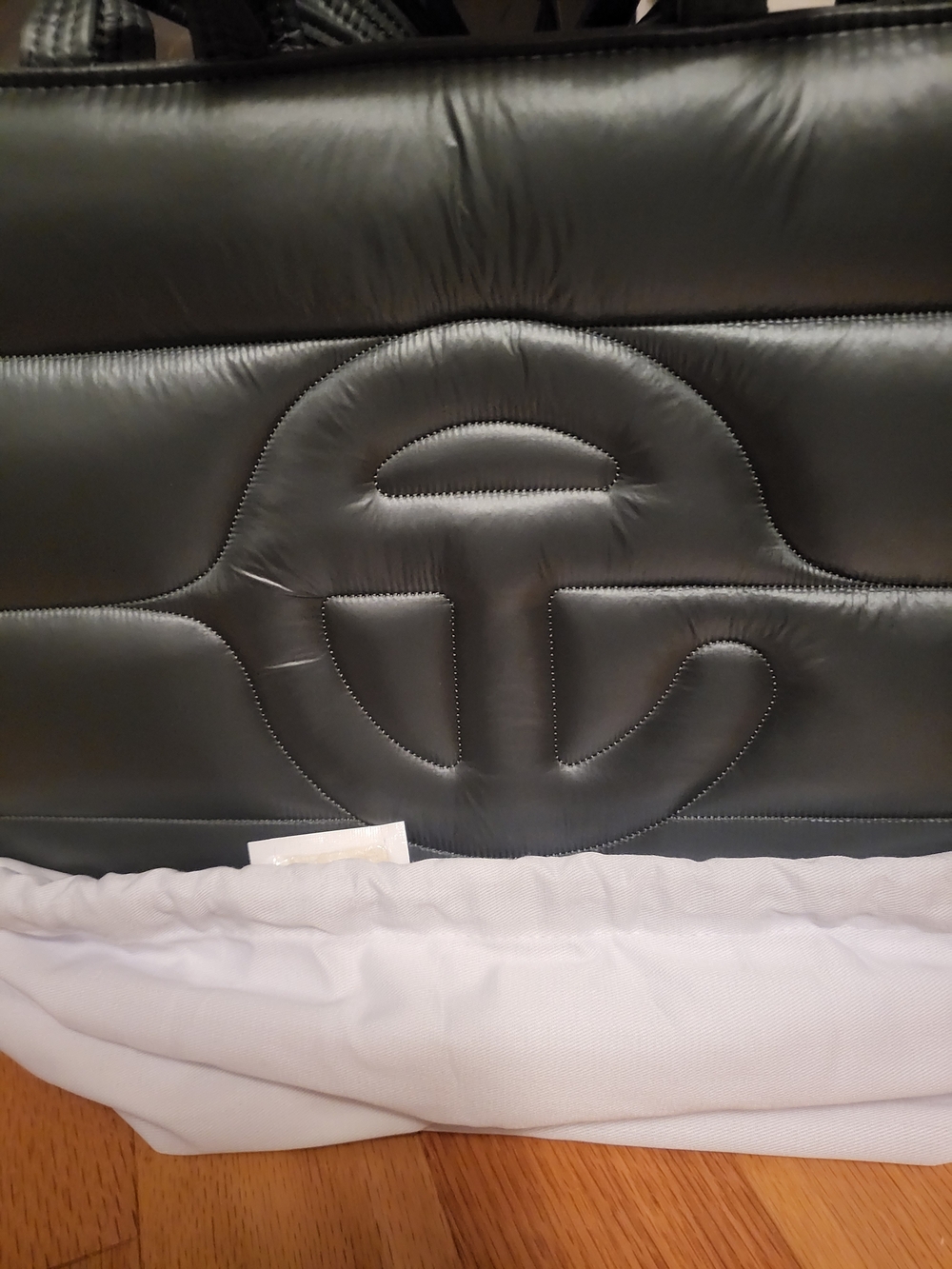 Padded Black Quilted Tote with Raised Circular Emblem